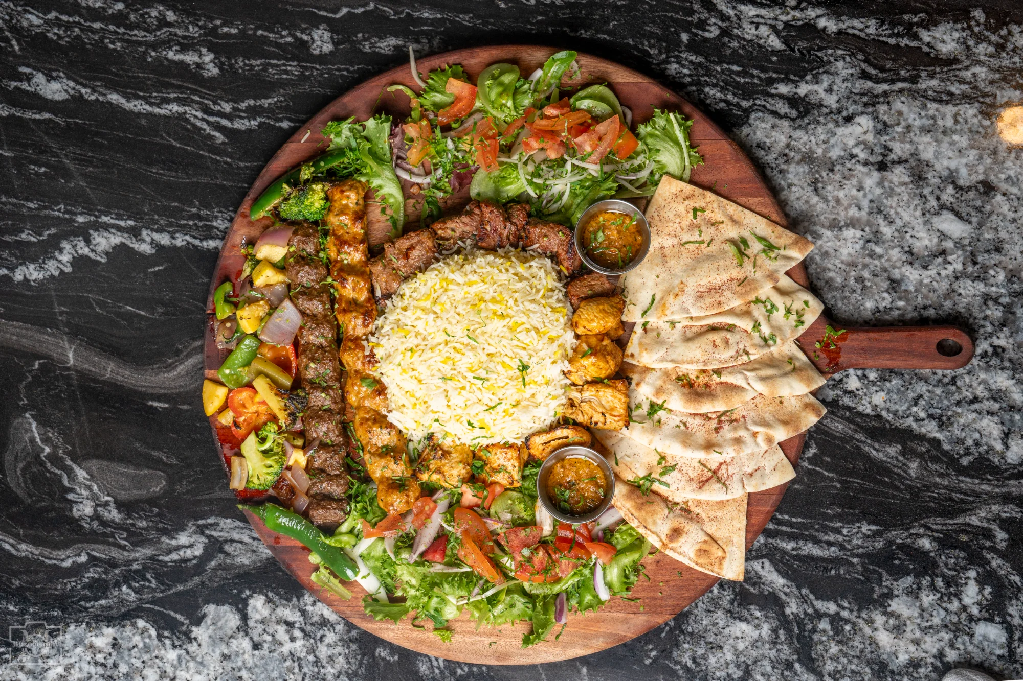 Mixed kebab platter with rice, salad and pita